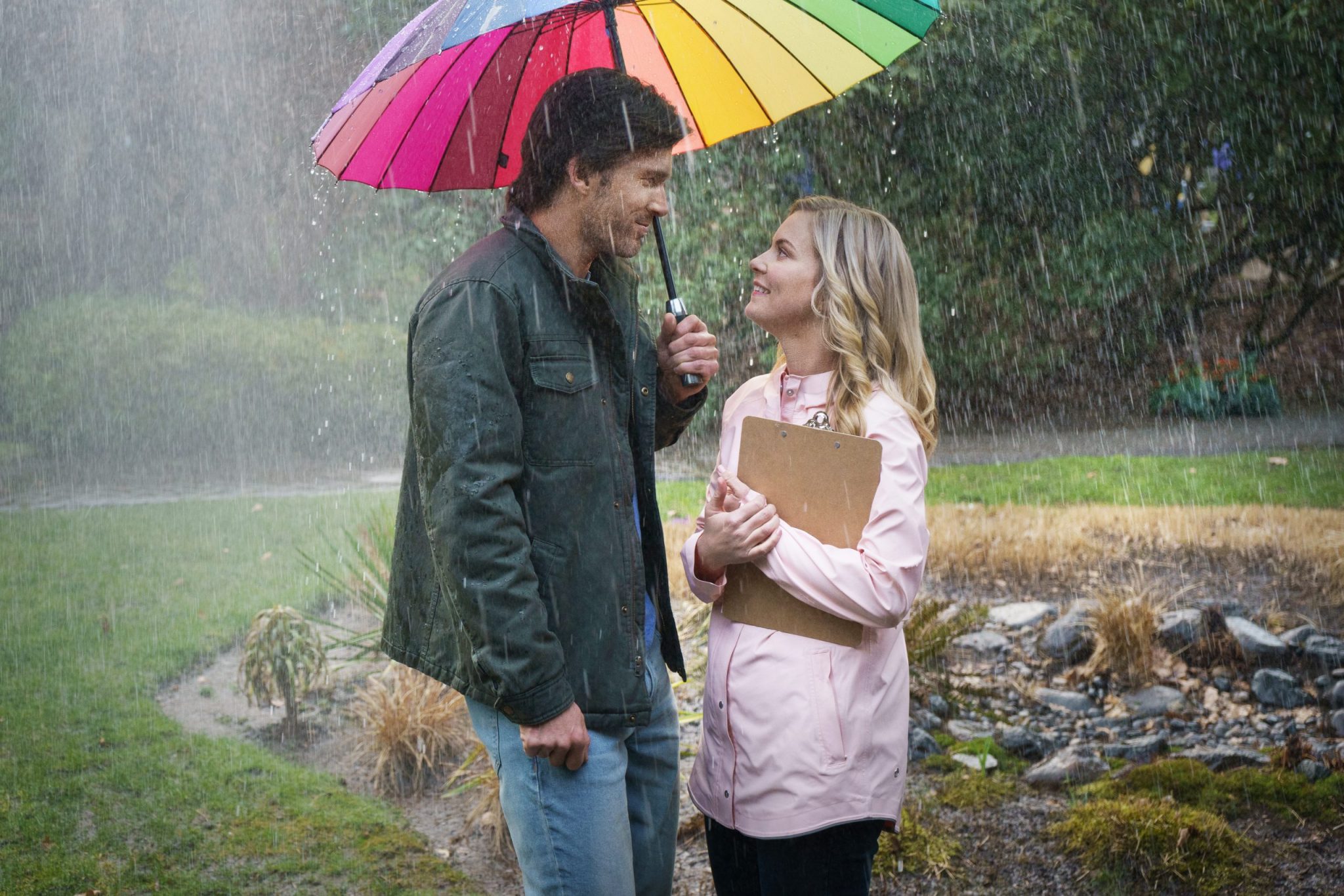 Hallmark, A Little Romance, On-air weather reporter Leah Waddell is getting weary of her bleak dating life and inability to be taken seriously as a budding meteorologist. At her wits end, she makes the decision to stay single and focus on her career for a full year. As soon as she makes this commitment, it literally starts pouring rain and men. As Leah deflects multiple romantic offers, she befriends her new neighbor Mark, a handsome dairy farmer who teaches her methods to predict the weather by observing signs in nature. Photo: Christopher Russell, Cindy Busby Credit: ©2020 Crown Media United States LLC/Photographer: Courtesy of Luba Popovic/Johnson Productions