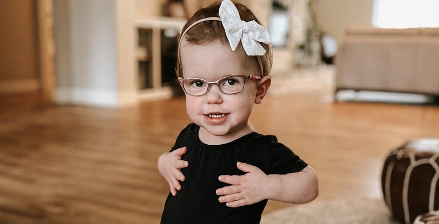 A little girl in a black leotard