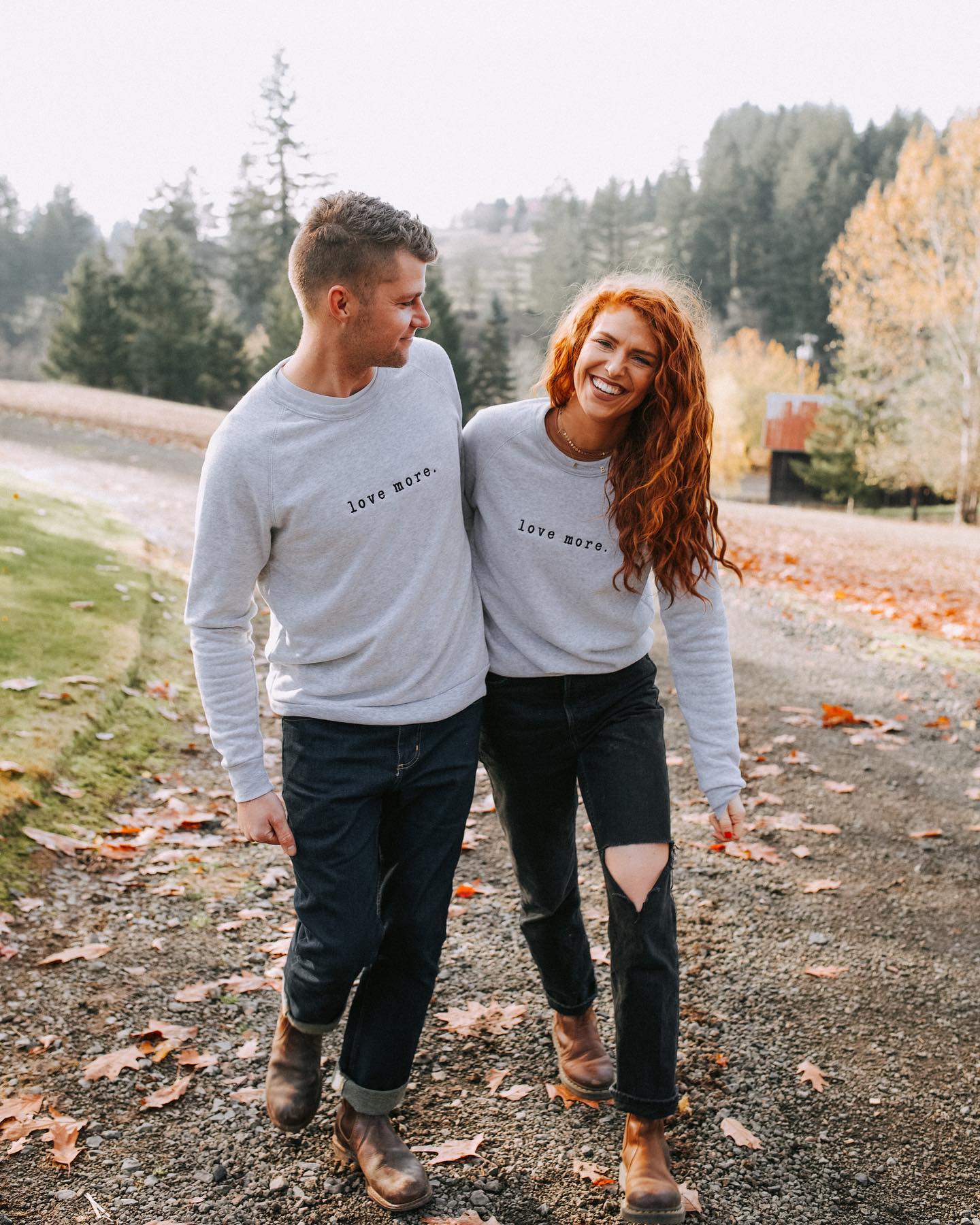 A man and a woman in matching gray sweaters