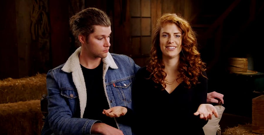 A man in a jean jacket and a woman with red hair