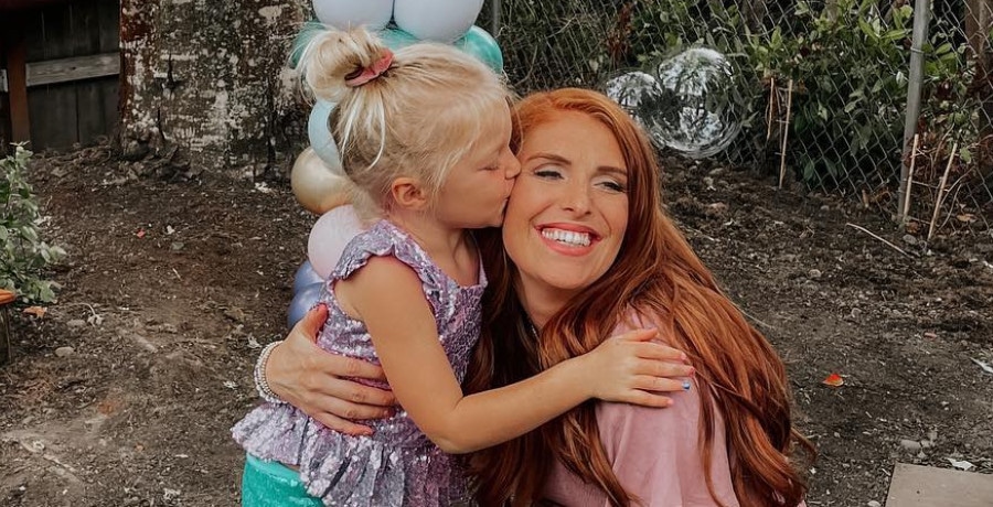 A little girl kissing her mom's cheek