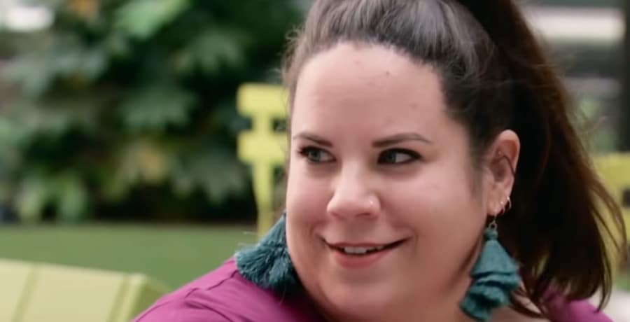 A woman with brown hair smiling