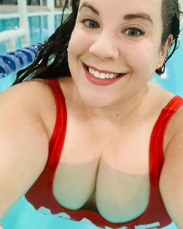 A busty woman in a red swimsuit