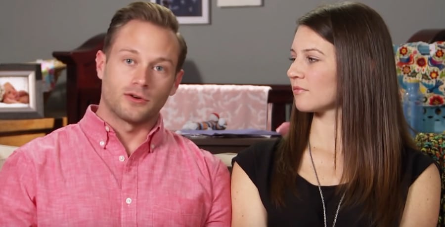 A woman looking at a man in a pink shirt