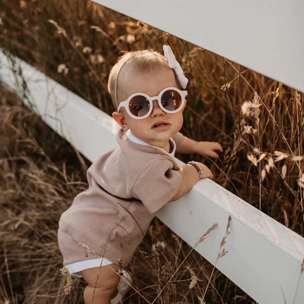 A little girl wearing sunglasses