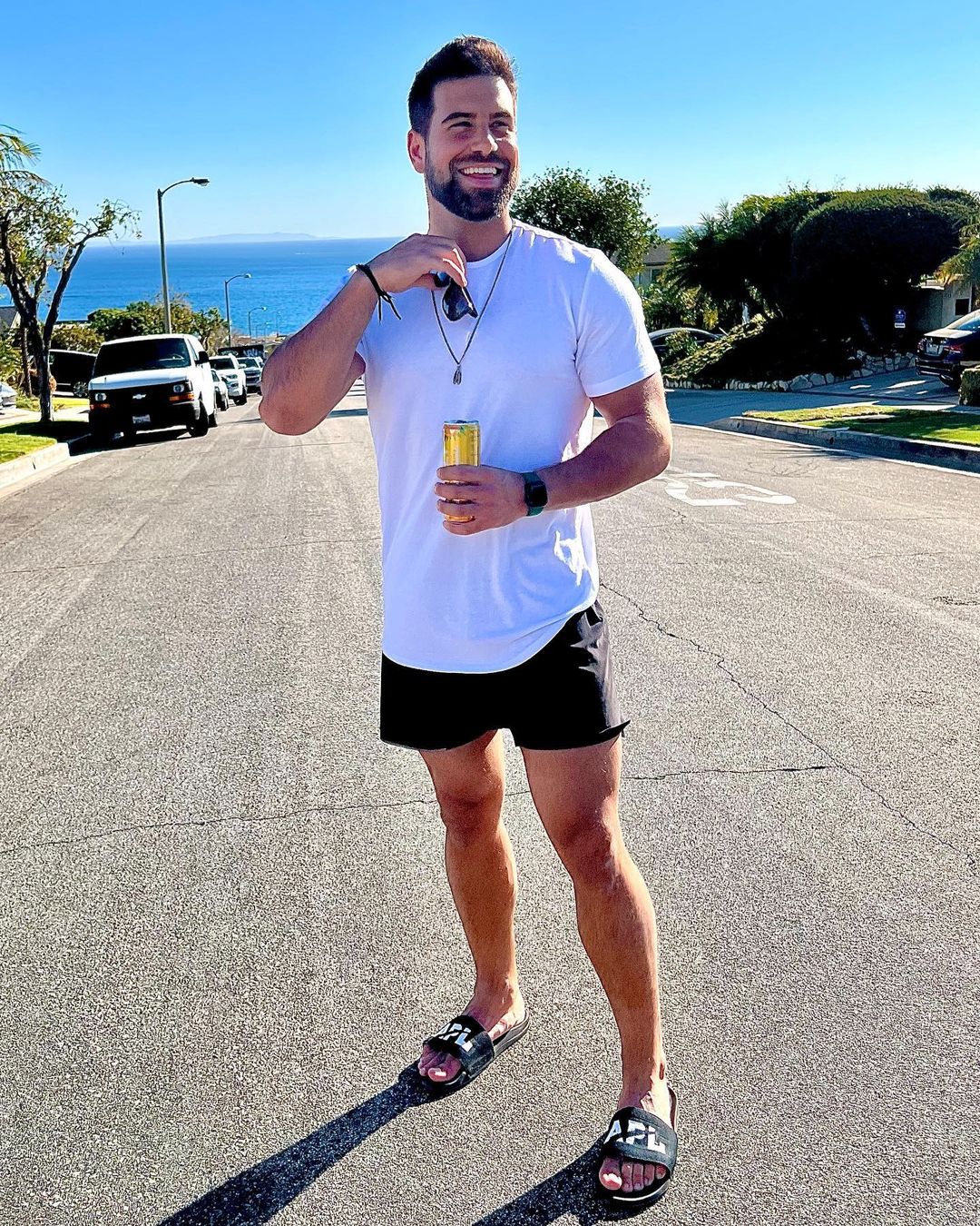 Blake Moynes - a man wearing a white shirt and short black shorts that show off his legs.