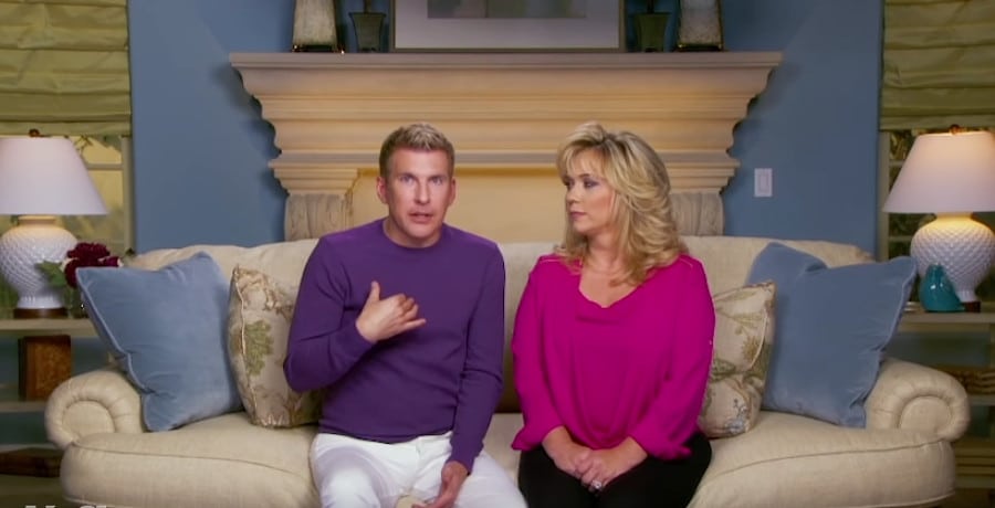A man in a purple sweater and a woman in a pink shirt