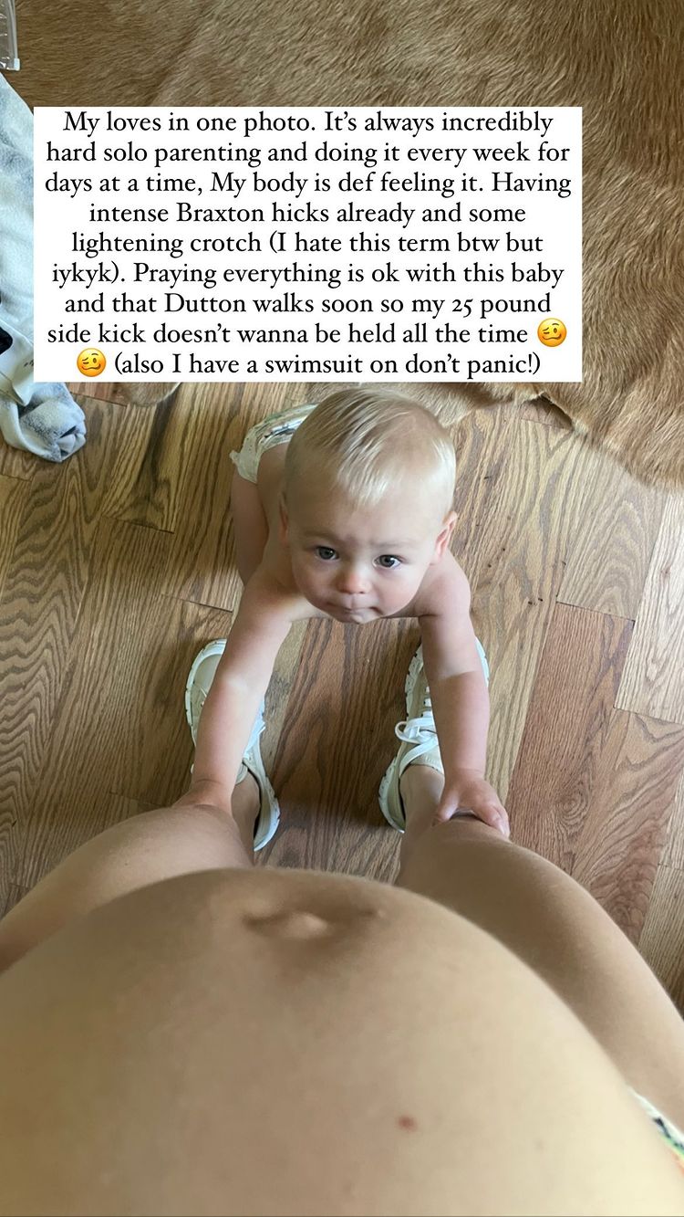 Lauren Lane: photo of a woman's bare belly bump with a young child at her knees