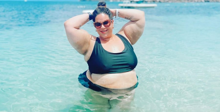 A large woman in a dark blue bikini 