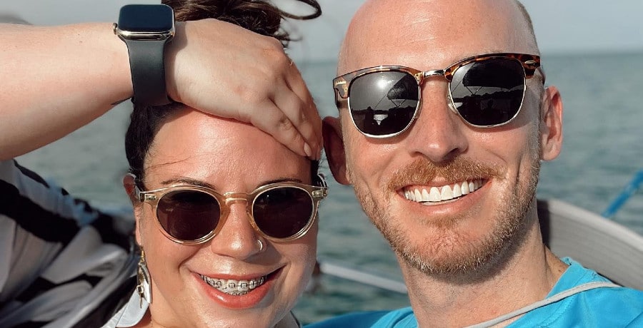 A man and a woman in black sunglasses