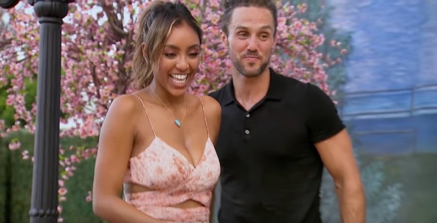 A woman in a pink dress and a man in a black shirt