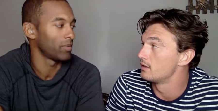 A Black man wearing a black shirt (Matt James) and a man in a striped shirt (Tyler Cameron.)