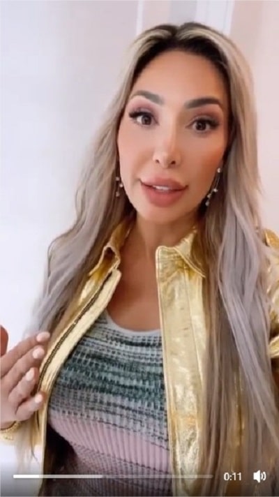 Farrah Abraham takes a selfie video in gold jacket and ribbed top.