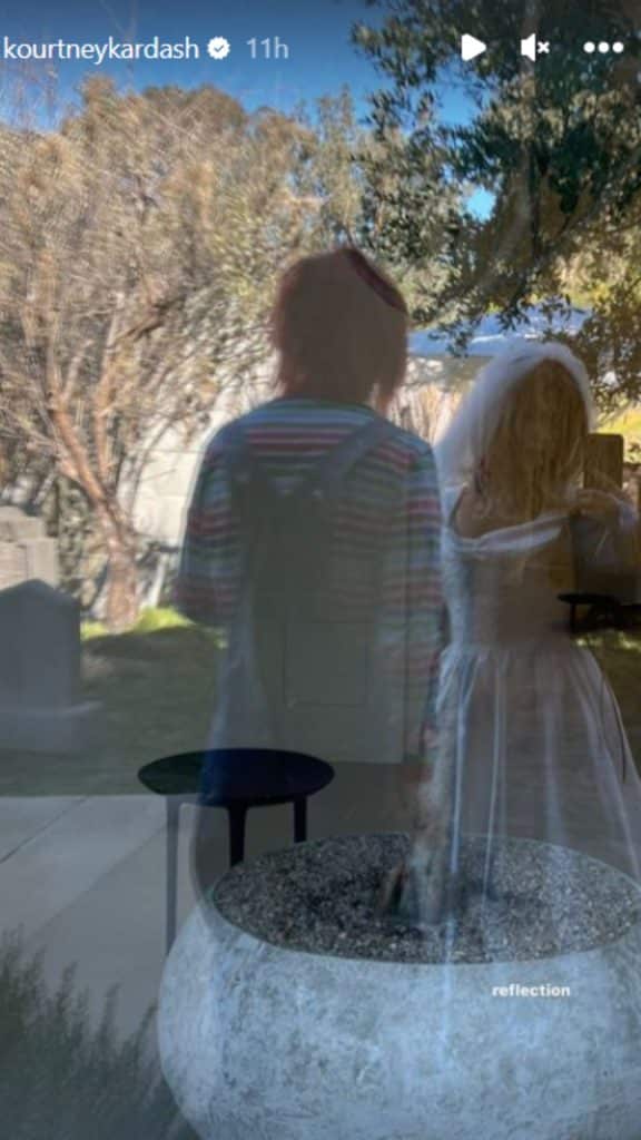 Kourtney and Travis Barker dressed as Chucky and Tiffany in reflective window - Instagram/Kourtney Kardashian