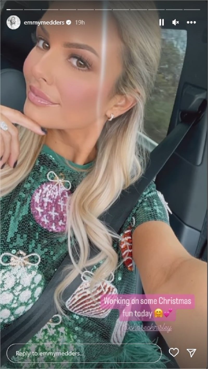 Emmy Medders takes a car selfie in a green Christmas dress.