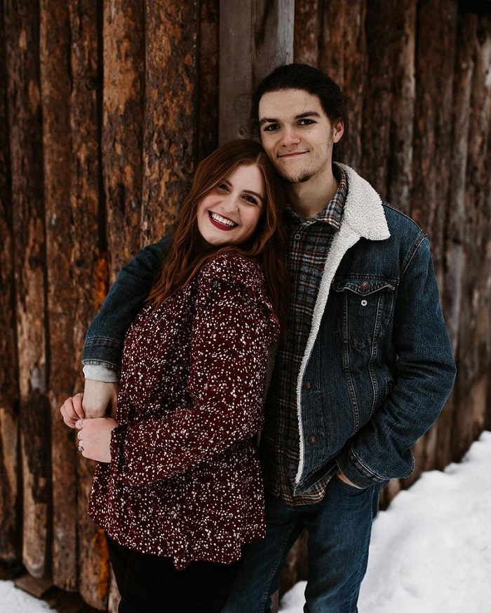 Isabel and Jacob Roloff hold each other close in snowy outdoor photo.