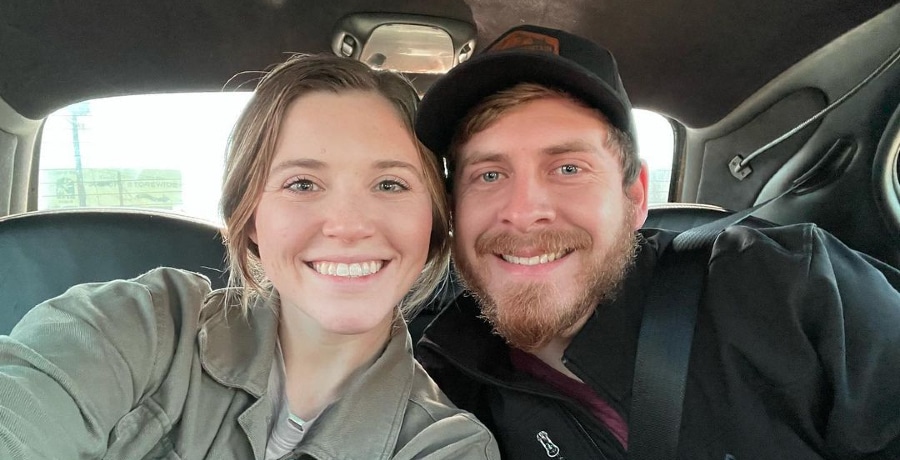 Joy and Austin Forsyth smile in car selfie.