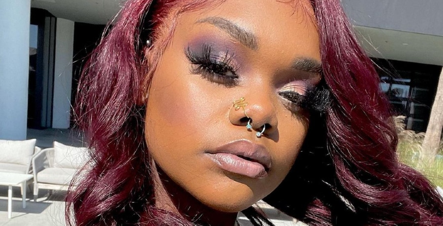 Close-up selfie of Kiaya Elliott with red curls and a nose ring.