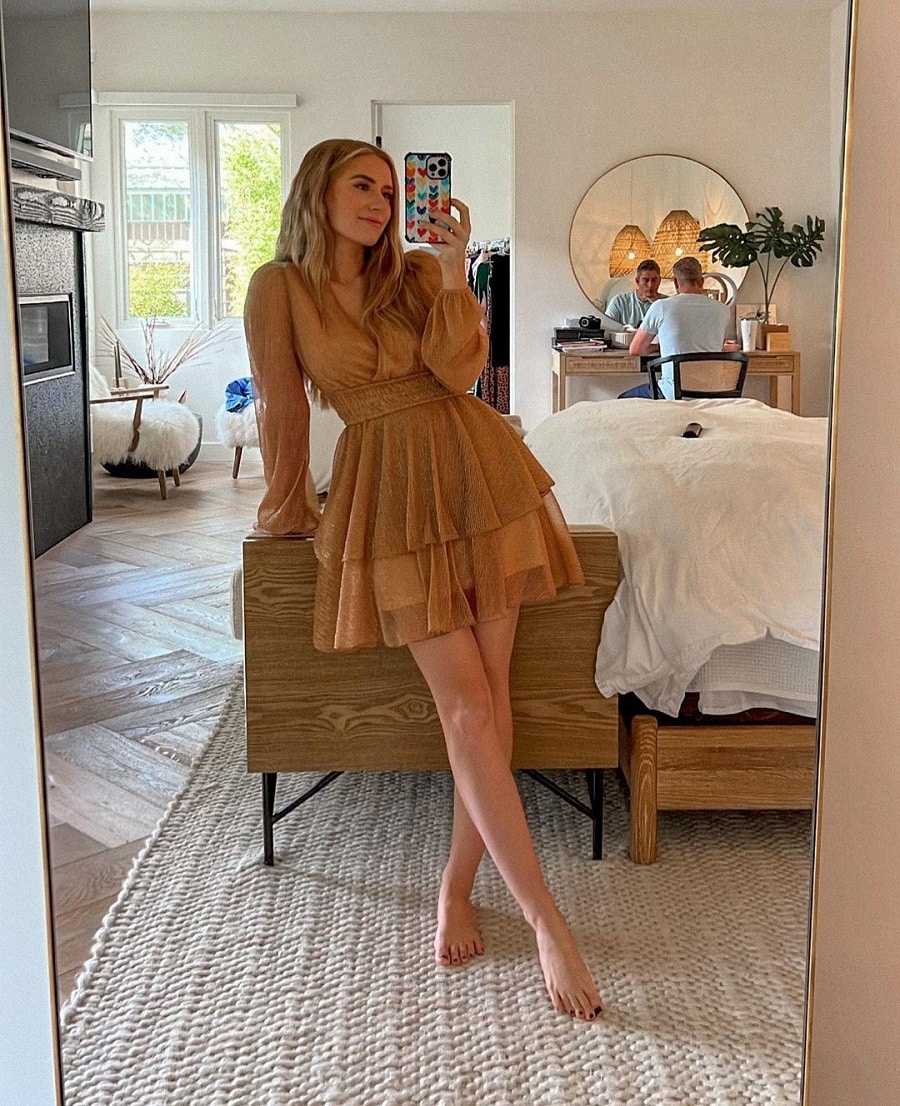 Lauren Luyendyk snaps a mirror selfie in sheer brown mini dress.