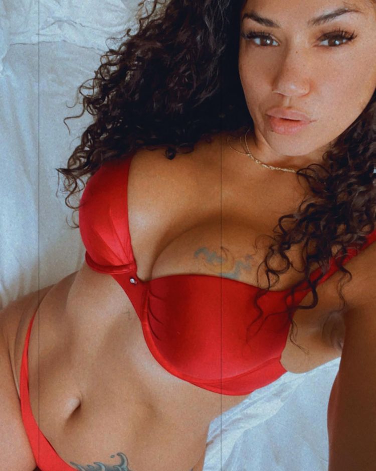 Pearl Gonzalez takes a selfie in bed in red underwear.