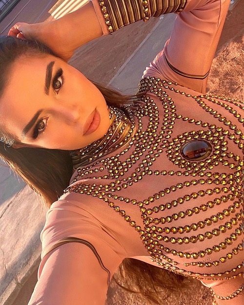 Demi Rose snaps a selfie in bedazzled cream top.