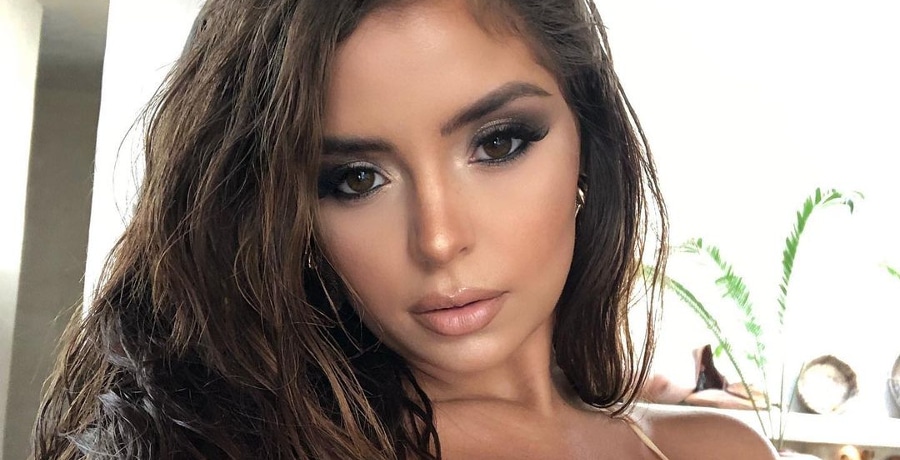 Demi Rose takes a selfie with smokey eye makeup.