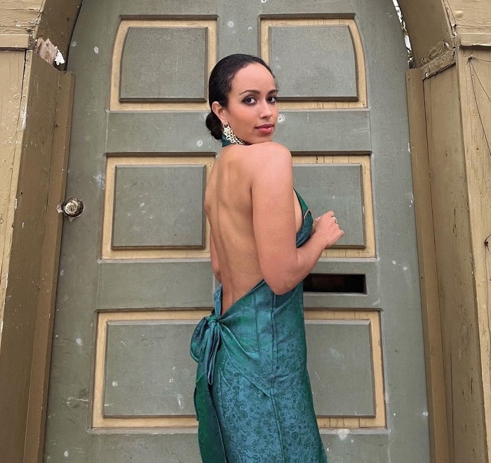 Kira Mengistu poses in a backless green dress.