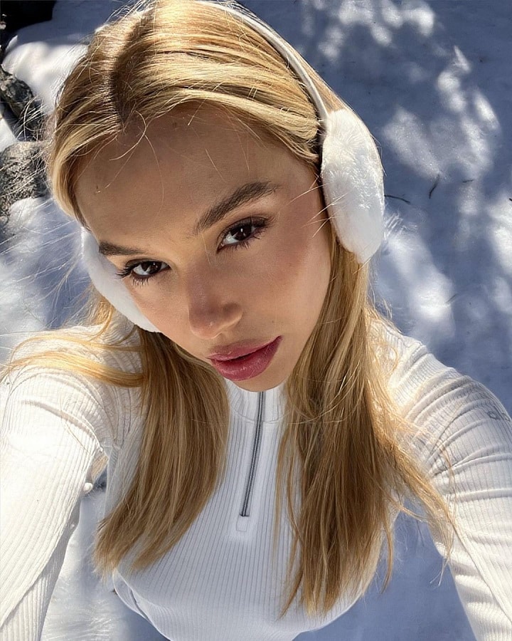 Alexis Ren Wears Earmuffs & Snowsuit [Alexis Ren | Instagram]