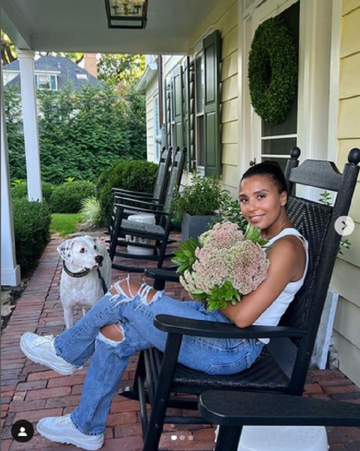 Marilee Fiebig Sits With Flowers In Rocking Chair [Marilee Fiebig | Instagram]