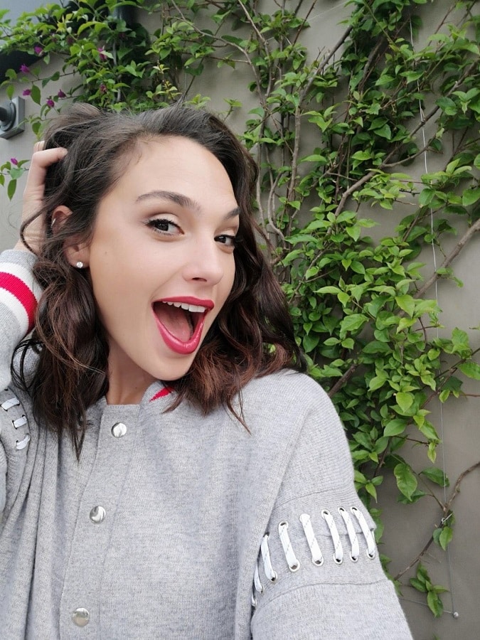 Gal Gadot Wears Gray & Red Sweater With Bold Lipstick [Source: Gal Gadot - Instagram]