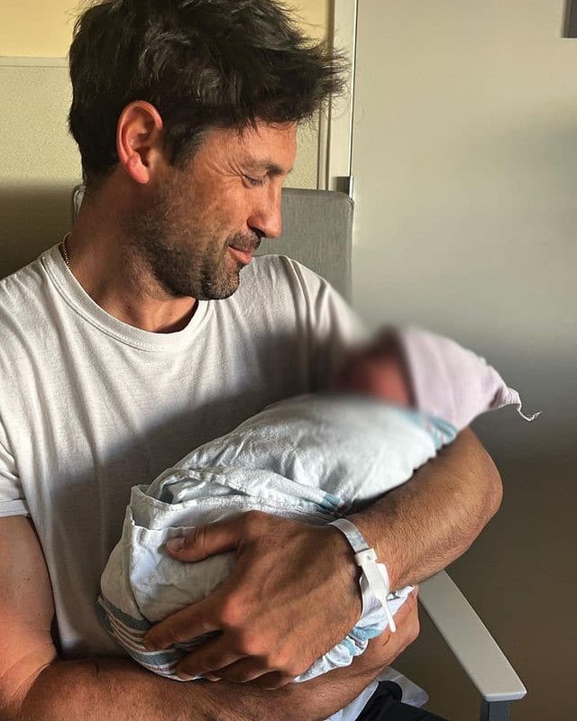 Maks Chmerkovskiy holding his son Rio from Instagram