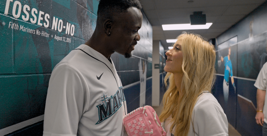 Kwame and Chelsea Appiah stand in hallway at Seattle Mariners