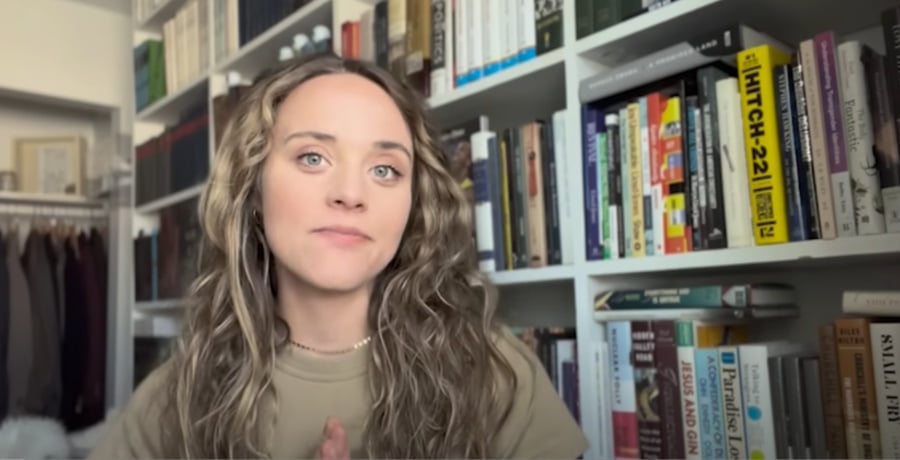 Jinger Duggar Vuolo sitting in front of large bookcase