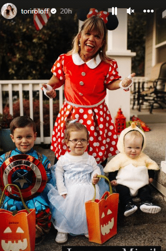 Amy Roloff, dressed as Minnie Mouse, poses with grandkids on Halloween night.