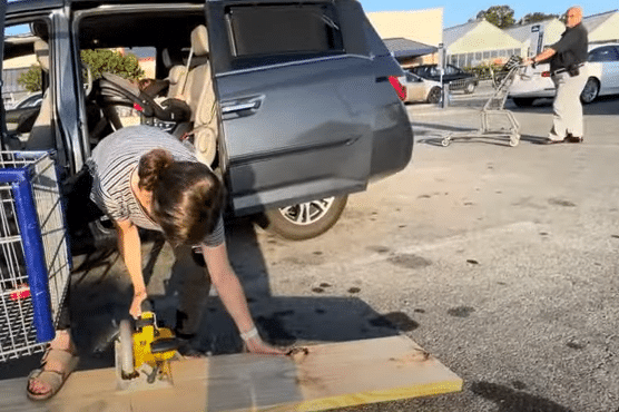 Jessa Duggar Seewald cutting wood in parking lot with circular saw.