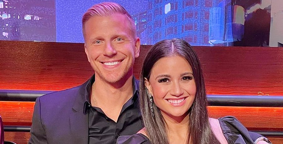 A man with blond hair sitting next to a woman with long brown hair.