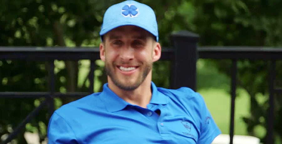 A man in a blue shirt and a blue baseball hat.