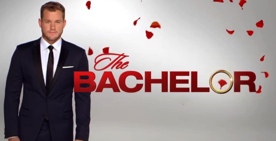 A man in a black tuxedo standing next to the word 'The Bachelor'