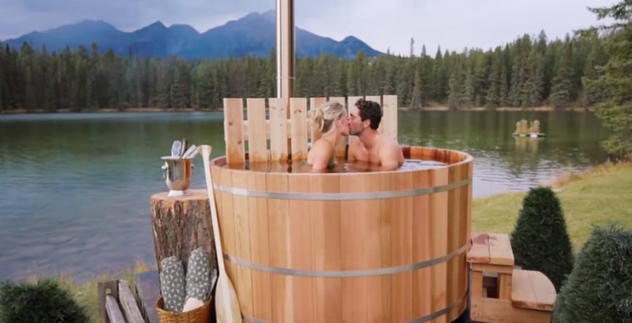 A man and a woman in an outdoor hot tub.