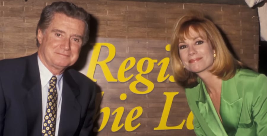 A man and a woman pose in front of a sign that says "Regis & Kathiee Lee"