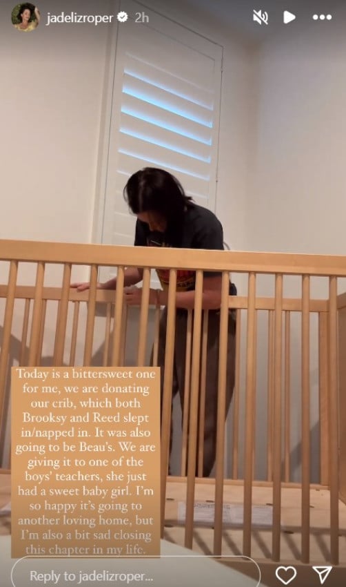 A woman taking a baby crib apart