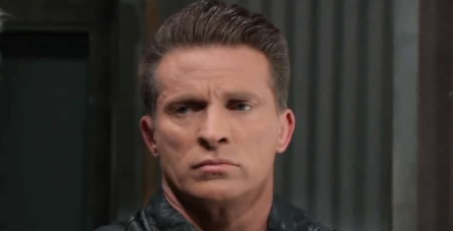A man in a black leather jacket looking angry.