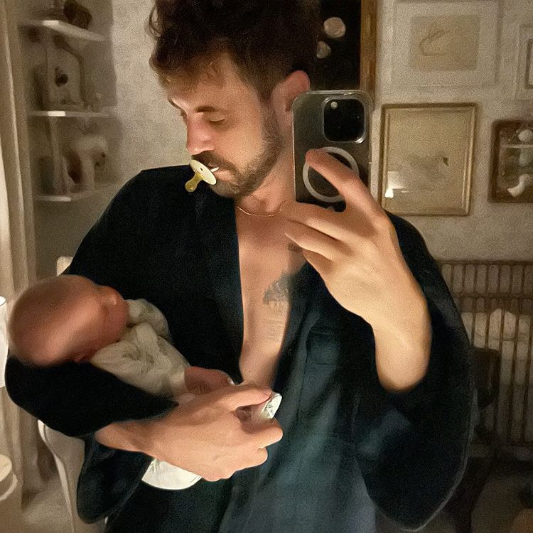 A man holding his newborn baby.