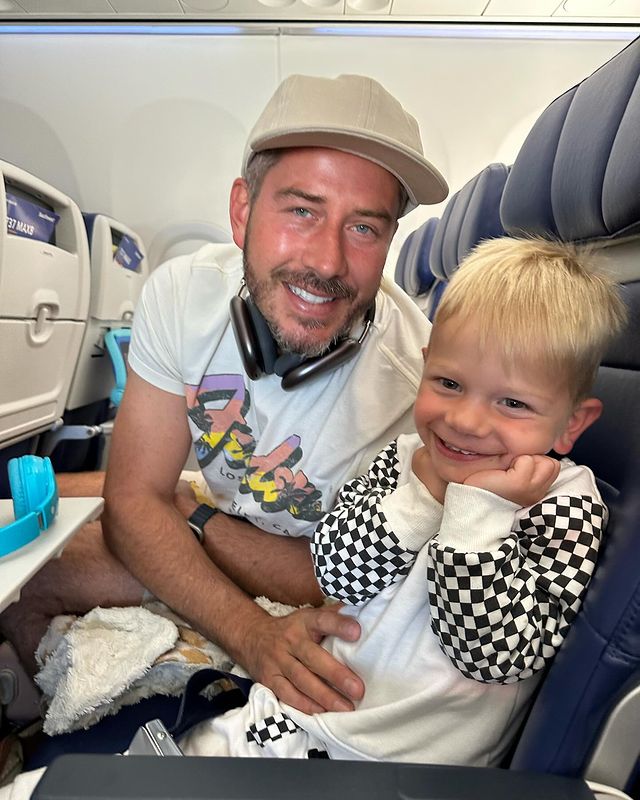 A man and his young son on a plane