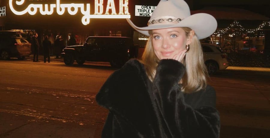 A woman with a brown cowboy hat on