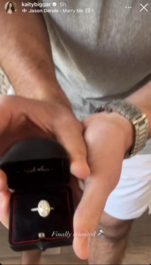 A photo of a man holding an engagement ring