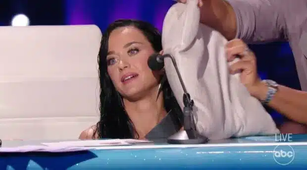 Luke Bryan puts a pillow in her face while she hides under the table. - American Idol