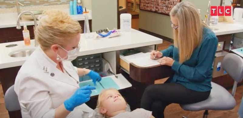 Orthodontist works on one of the Busby quints, sourced from OutDaughtered sneak peek on PEOPLE
