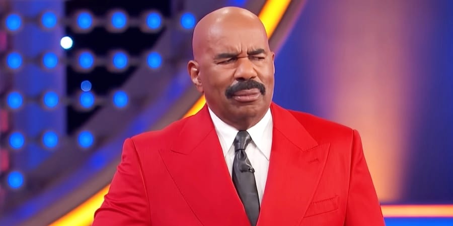 Steve Harvey cringes but allows Shirley to explain. - Family Feud