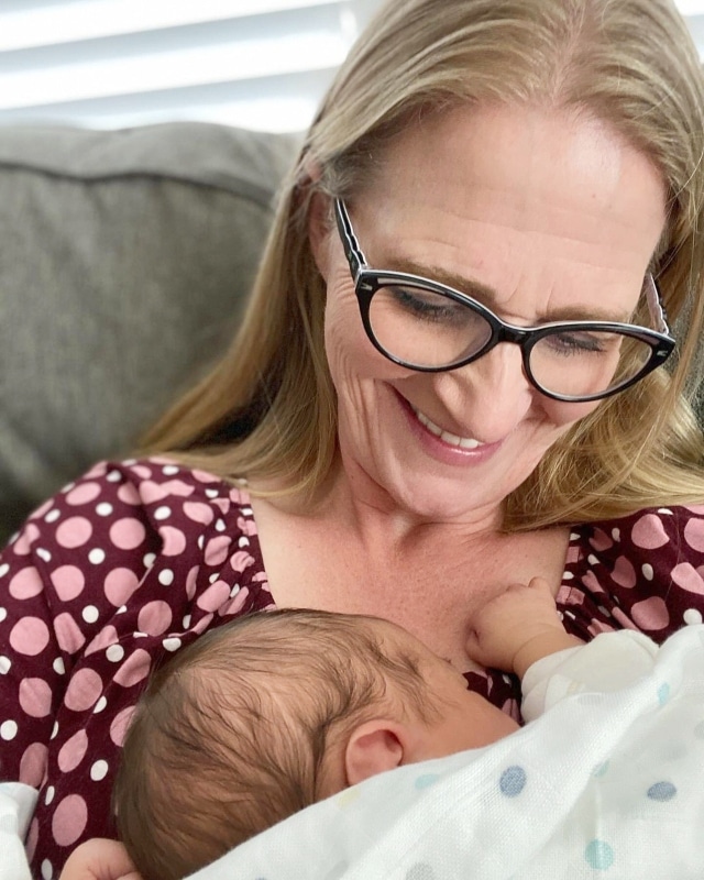 Christine Brown holding one of her grandchildren from Mykelti Padron's Instagram